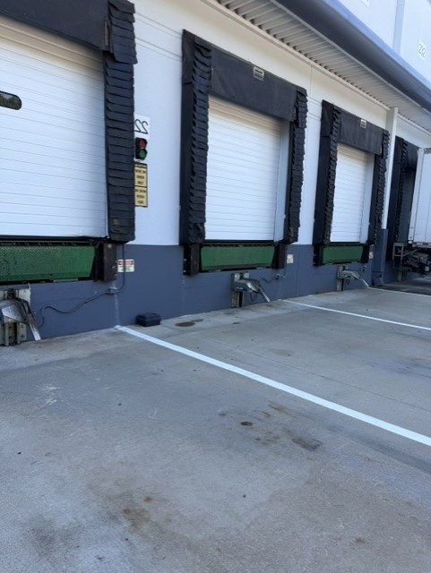 Loading dock bays with sealed doors at industrial facility